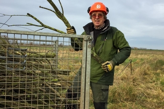 Martin Parsons loading and removing unwanted sallow that cannot be burnt on peat