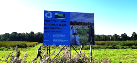 Entrance board at entrance to De Korremof Farm. In dutch is says 'Trial with wet agriculture against soil subsidence'