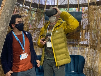 Chris Packham trying the VR headset at COP26 Peatland Pavilion