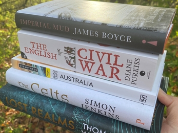 Stack of books held in a hand