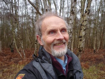 Alan Bowley in silver birch woodland wearing a Natural England jacket