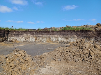 Land dug a few metres deep showing different colour layers