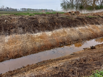 Land dug a few metres deep in a drain trench showing different colour layers