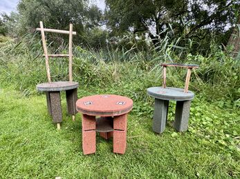 Three stools made of red, green and brown particleboard 