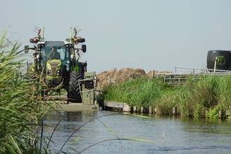 How to move farm machinery in the Netherlands – tractor on pontoon floating on water
