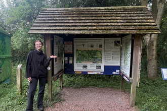 Lucy stands in front of the Great Fen information hut