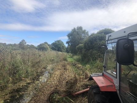 Tractor raking at Woodwalton Fen