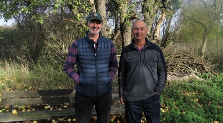 Andrew Cuthbert and Geoff Willis stand under an apple tree