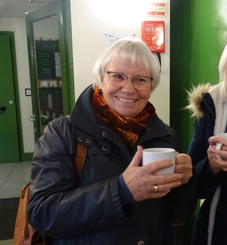 Caroline Lewis holding a mug and smiling