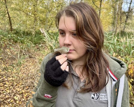 Kaitlyn holds an aniseed fungi up to smell it