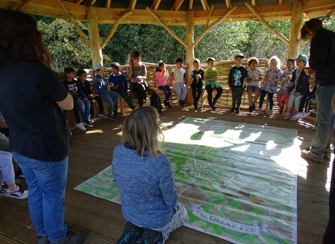 Ramsey Heights outdoor shelter with school children and Great Fen map